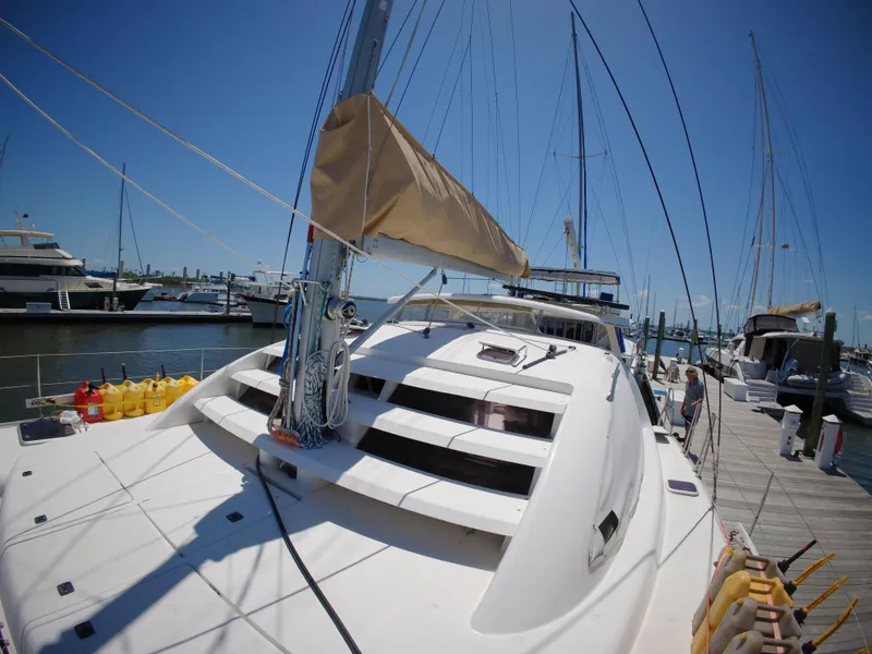 Slide: The Image of 2005 Leopard 40 catamaran docked at marina under clear blue sky. - 4