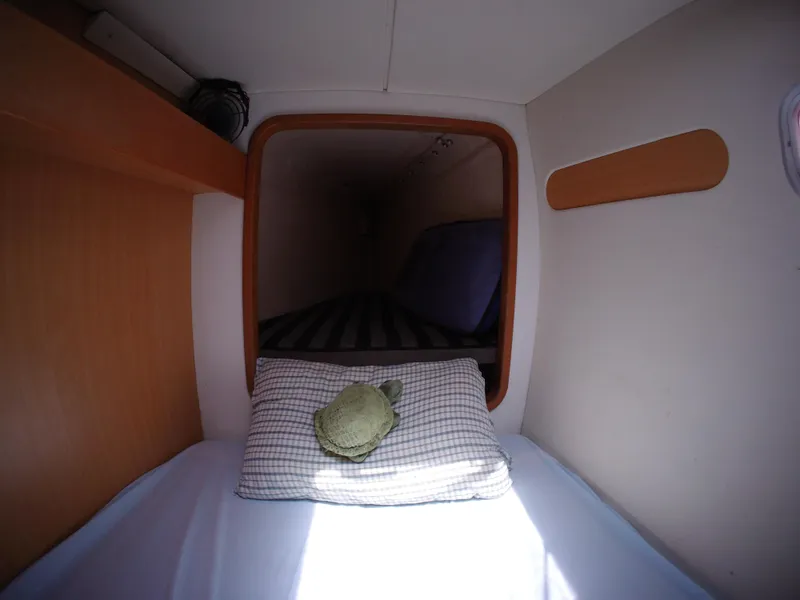 Slide: The Image of Cozy cabin interior of a 2005 Leopard 40 catamaran with a neatly made bed. - 48