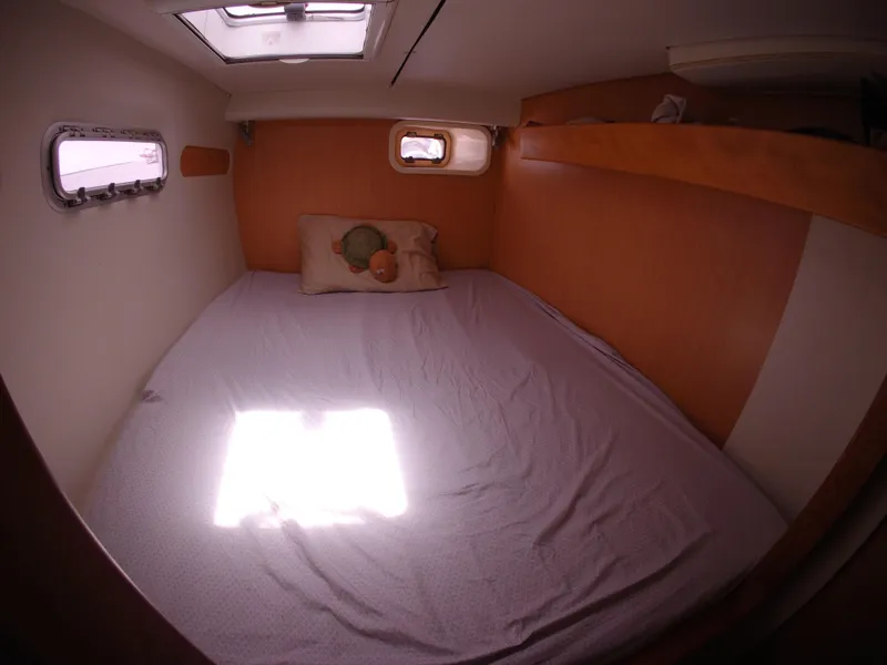 Slide: The Image of Cozy cabin interior of 2005 Leopard 40 catamaran with bed and portholes. - 49