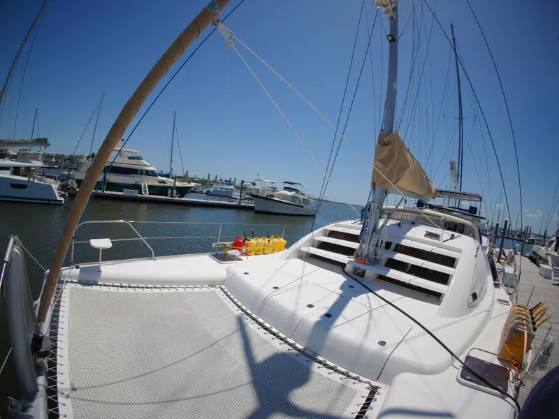 Slide: The Image of Catamaran Leopard 40, 2005 model, docked at marina with clear blue sky. - 5