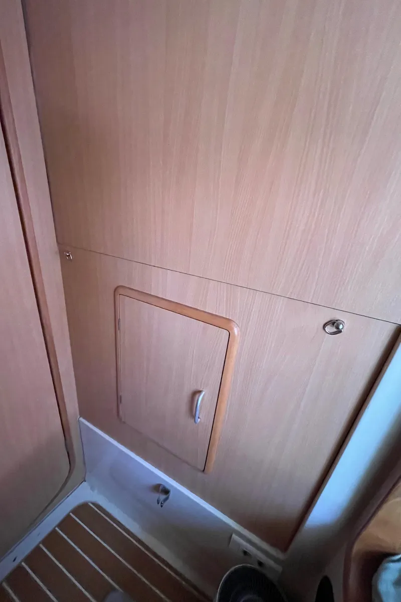 Slide: The Image of Wooden interior paneling with a small door on a 2005 Leopard 40 yacht. - 52