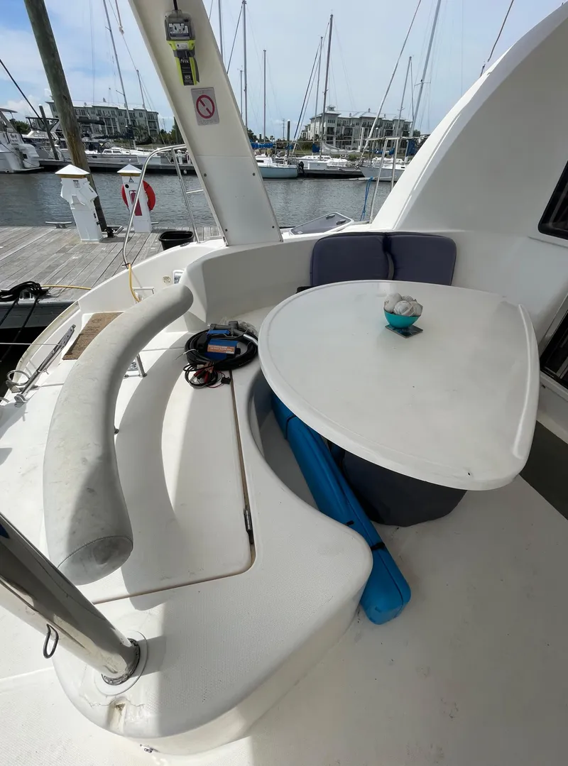 Slide: The Image of Leopard 40 catamaran cockpit with seating and table, docked at marina, 2005 model. - 6