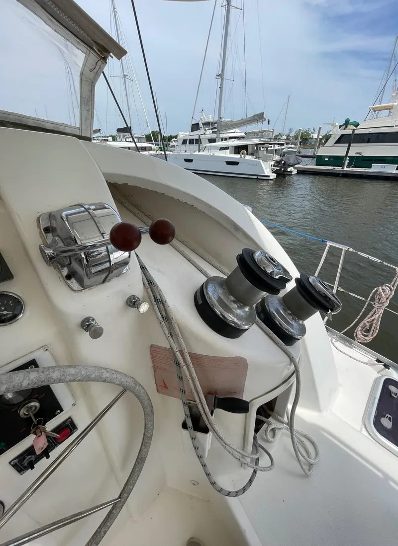 Slide: The Image of Leopard 40 sailboat cockpit with winches and controls, docked in a marina, 2005 model. - 7