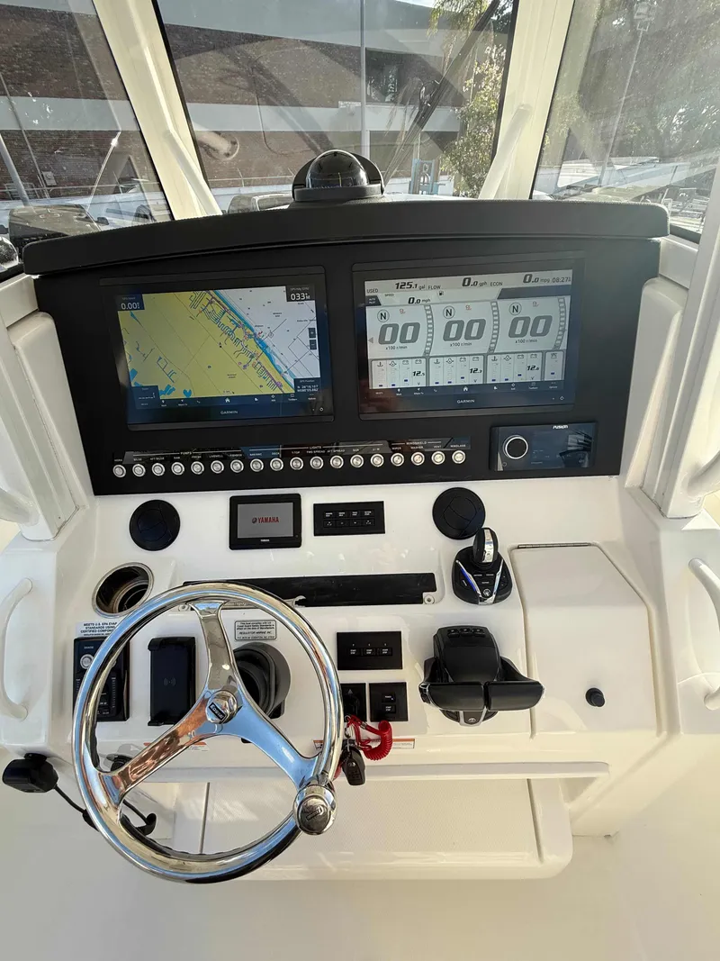 Slide: The Image of 2023 Regulator 34 boat dashboard with navigation screens and controls. - 17