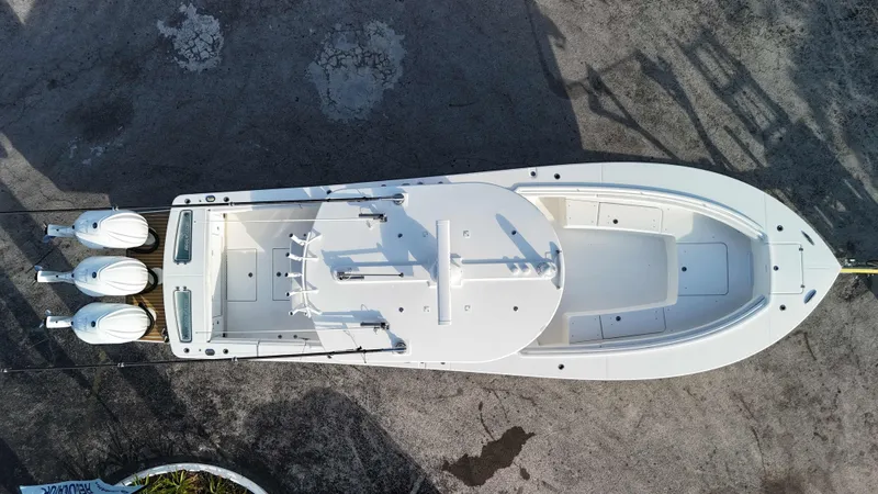 Slide: The Image of Aerial view of 2023 Regulator 34 boat with triple engines on a concrete surface. - 2