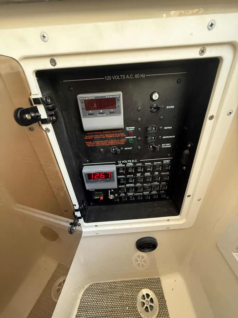 Slide: The Image of Electrical panel of 2023 Regulator 34 boat, showing voltage and circuit controls. - 25
