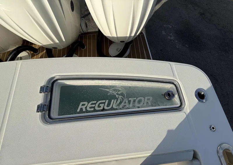 Slide: The Image of 2023 Regulator 34 boat deck with logo and storage compartment. - 26