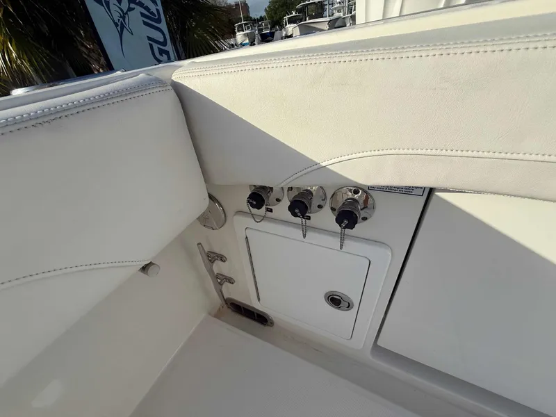 Slide: The Image of 2023 Regulator 34 boat interior with control panel and storage compartment. - 30