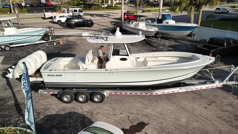 Slide: The Image of 2023 Regulator 34 boat on trailer, parked outdoors, side view. - 41