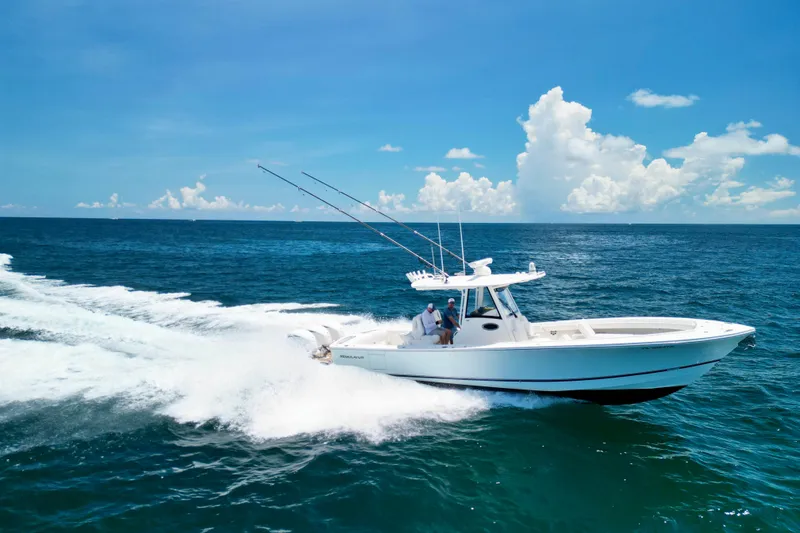 Slide: The Image of 2023 Regulator 34 boat cruising on open ocean under clear blue sky. - 43