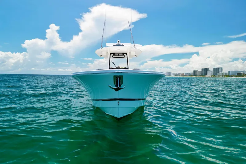 Slide: The Image of 2023 Regulator 34 boat on ocean with city skyline in background. - 44