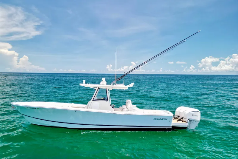 Slide: The Image of 2023 Regulator 34 boat on clear blue ocean under sunny sky. - 46