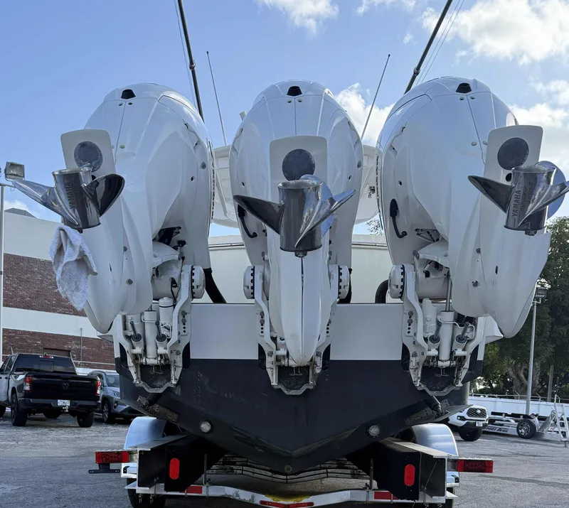 Slide: The Image of 2023 Regulator 34 boat with triple outboard engines on a trailer. - 6
