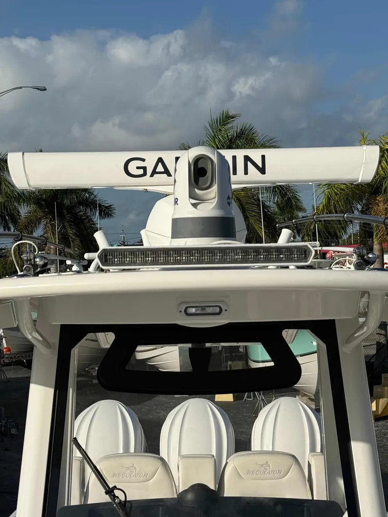 Slide: The Image of 2023 Regulator 34 boat with Garmin radar, palm trees in background. - 9