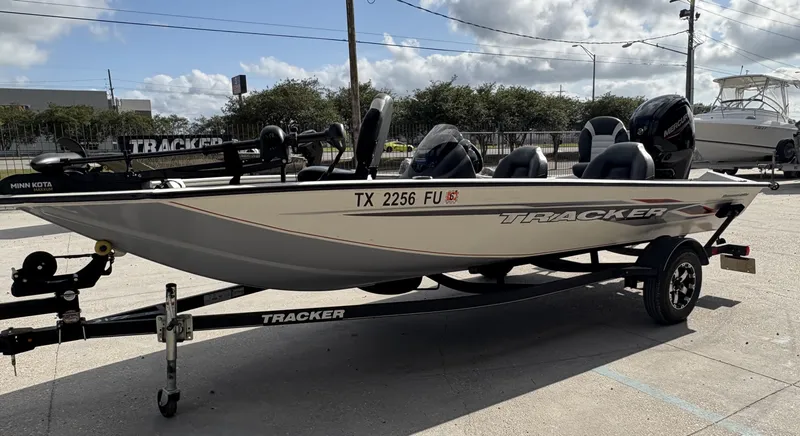Slide: The Image of 2020 Tracker Pro Team 175 boat on trailer, parked outdoors under cloudy sky. - 5