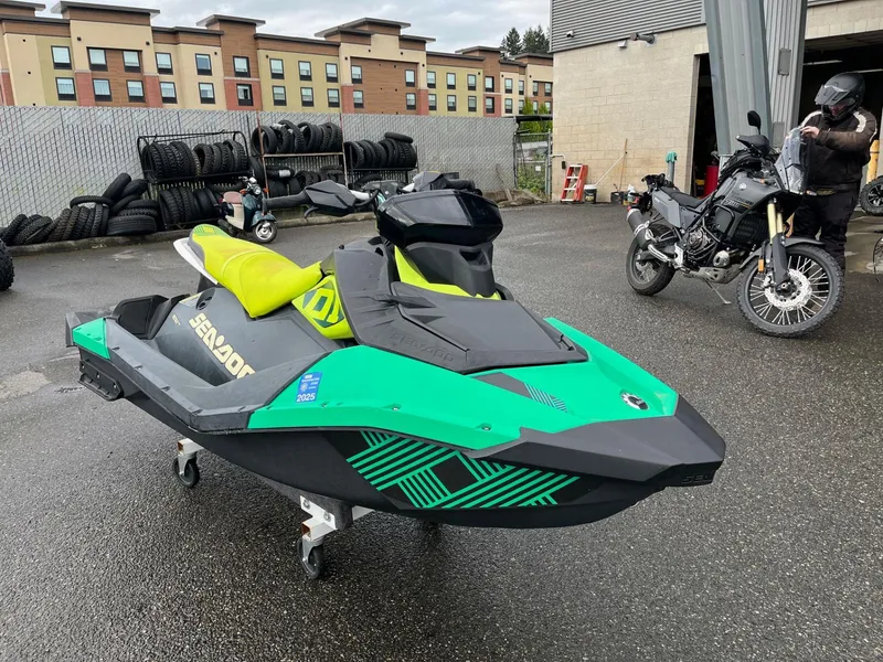 Slide: The Image of 2019 Sea-Doo Spark 2up 900 H.O. ACE jet ski parked outdoors near motorcycle. - 4