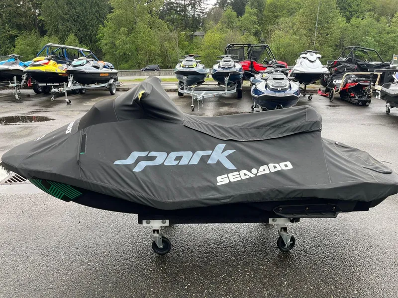 Slide: The Image of 2019 Sea-Doo Spark 2up 900 H.O. ACE covered, parked among other watercraft. - 7