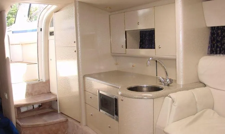 Slide: The Image of Interior of 2002 Formula 400 SS boat with kitchenette and seating area. - 10