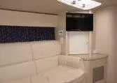 Slide: The Image of Interior of 2002 Formula 400 SS boat with white seating and mounted TV. - 11