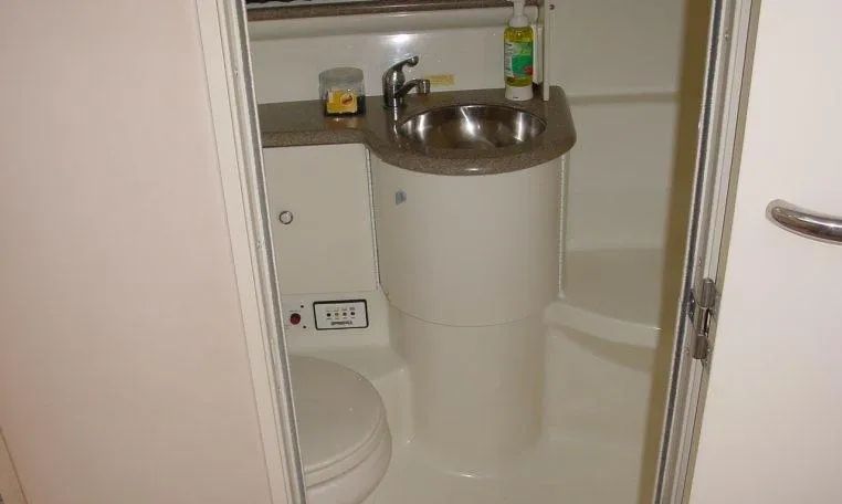 Slide: The Image of Compact bathroom in a 2002 Formula 400 SS boat, featuring a sink and toilet. - 12