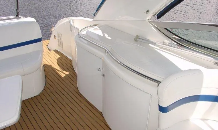 Slide: The Image of 2002 Formula 400 SS boat interior with white seating and wooden deck. - 13