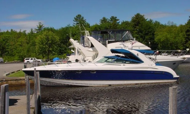 Slide: The Image of 2002 Formula 400 SS boat docked in a serene marina setting. - 15