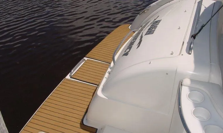 Slide: The Image of 2002 Formula 400 SS boat with teak swim platform on calm water. - 3