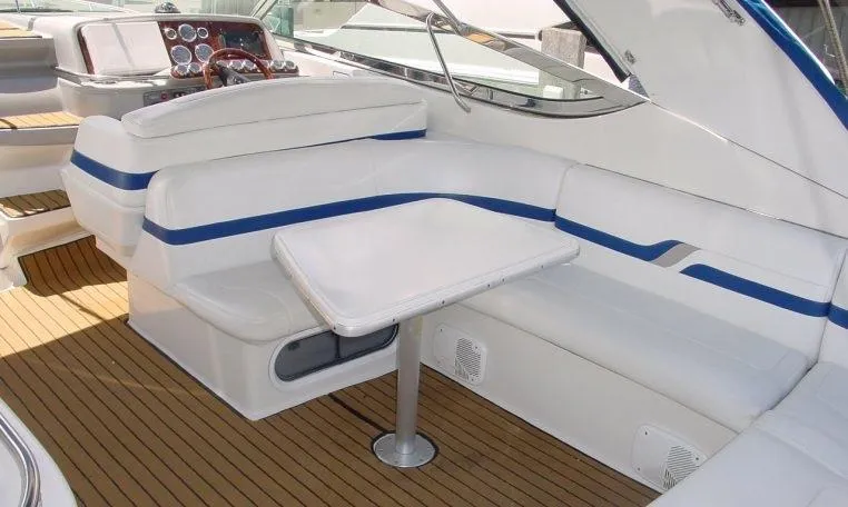 Slide: The Image of 2002 Formula 400 SS boat interior with white seating and wooden flooring. - 4