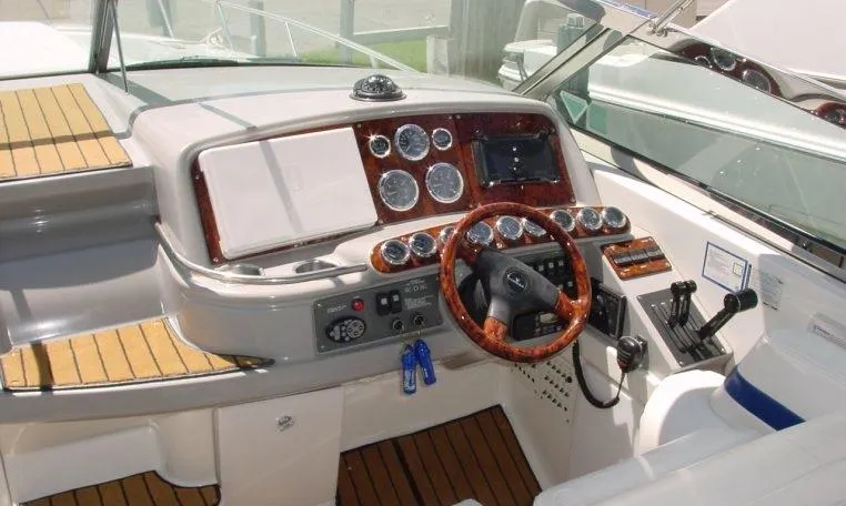 Slide: The Image of 2002 Formula 400 SS boat dashboard with wood accents and modern controls. - 5
