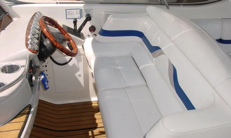 Slide: The Image of 2002 Formula 400 SS boat interior with white seating and wooden steering wheel. - 7