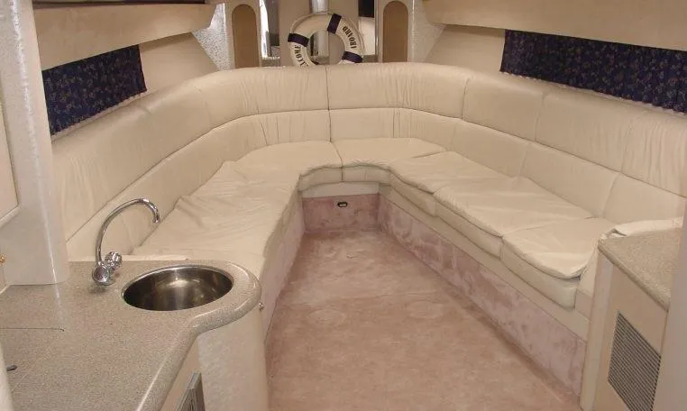 Slide: The Image of Luxurious interior of a 2002 Formula 400 SS boat with plush seating and kitchenette. - 8