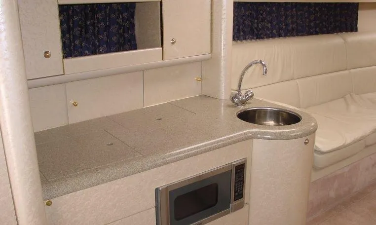 Slide: The Image of 2002 Formula 400 SS boat interior with kitchenette, sink, and microwave. - 9