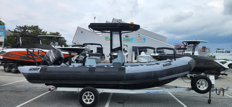 Slide: The Image of 2011 Zodiac Milpro 2100 LE boat on trailer, parked in a marina lot. - 1