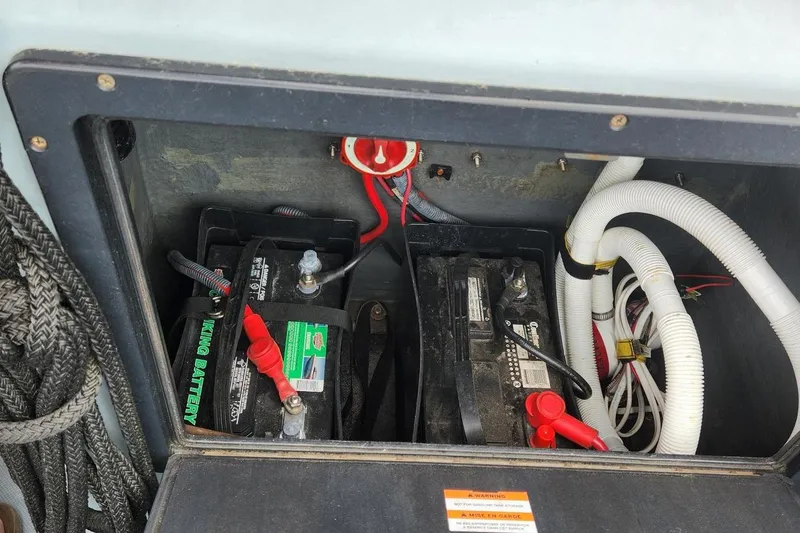 Slide: The Image of Battery compartment of a 2011 Zodiac Milpro 2100 LE with wiring and hoses visible. - 11