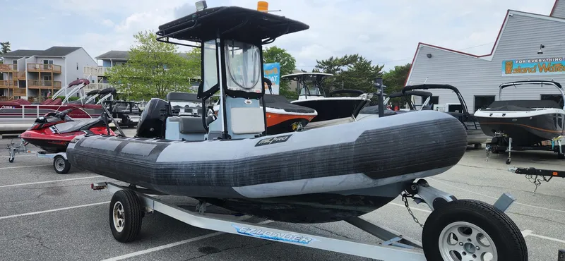 Slide: The Image of Zodiac Milpro 2100 LE 2011 inflatable boat on trailer in parking lot. - 2