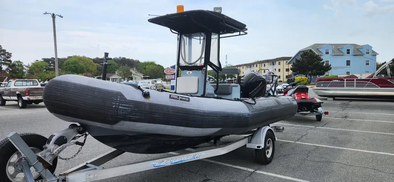 Slide: The Image of Zodiac Milpro 2100 LE 2011 inflatable boat on trailer in parking lot. - 3