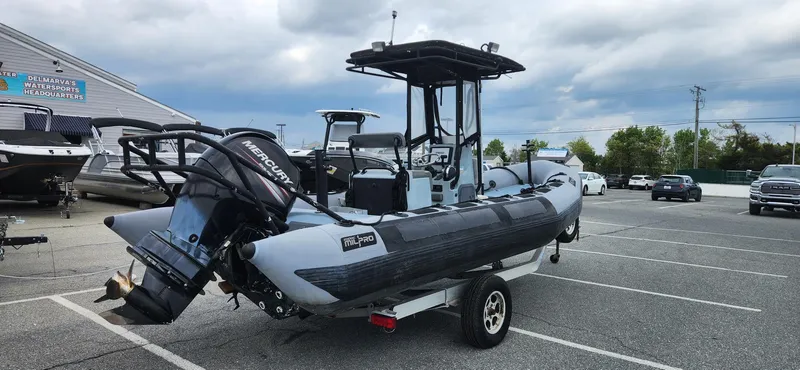 Slide: The Image of Zodiac Milpro 2100 LE 2011 boat on trailer in parking lot, overcast sky. - 4