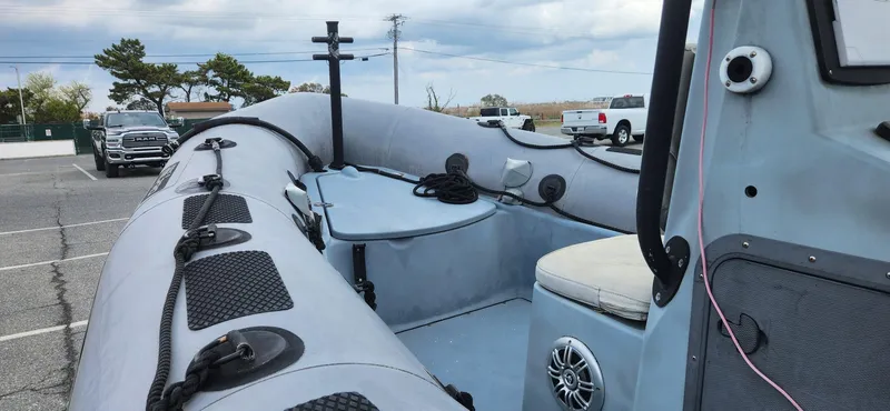 Slide: The Image of Zodiac Milpro 2100 LE inflatable boat, 2011 model, parked in a lot with vehicles. - 7