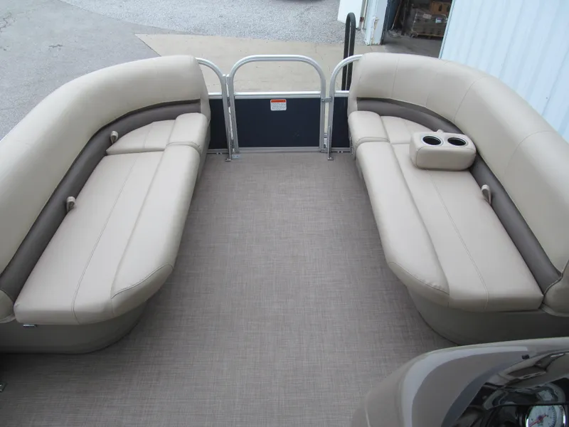 Slide: The Image of 2020 Sun Tracker Party Barge 18 DLX interior with beige seating and cup holders. - 6