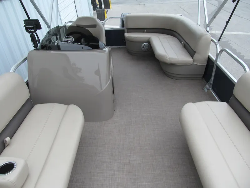 Slide: The Image of 2020 Sun Tracker Party Barge 18 DLX interior with beige seating and helm. - 7