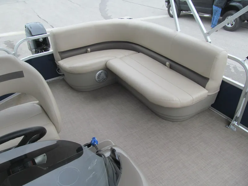 Slide: The Image of 2020 Sun Tracker Party Barge 18 DLX interior with beige seating and steering console. - 8