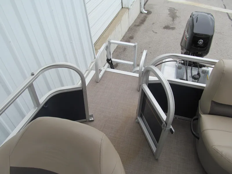 Slide: The Image of 2020 Sun Tracker Party Barge 18 DLX pontoon boat interior with seating and motor. - 9
