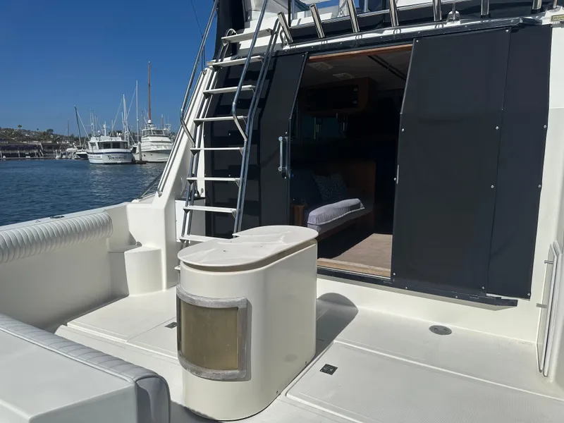 Slide: The Image of 1991 Symbol 39 Sedan Sportfisher boat deck with ladder and open cabin door. - 10
