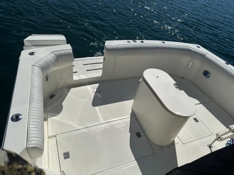 Slide: The Image of 1991 Symbol 39 Sedan Sportfisher boat deck with seating, on calm water. - 11