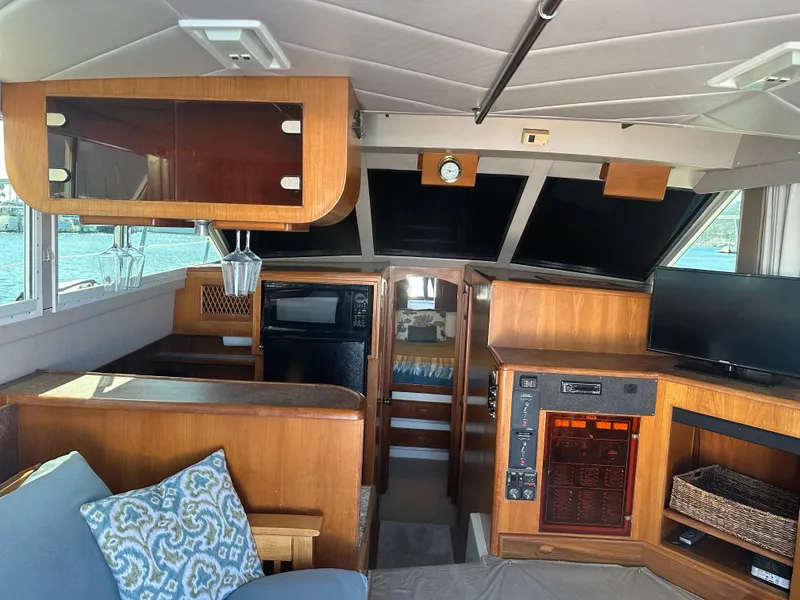 Slide: The Image of Interior of a 1991 Symbol 39 Sedan Sportfisher with wood finishes and modern amenities. - 18