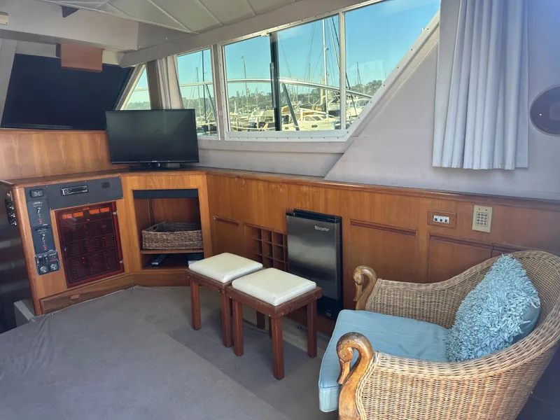 Slide: The Image of Interior of a 1991 Symbol 39 Sedan Sportfisher with seating, TV, and marina view. - 20
