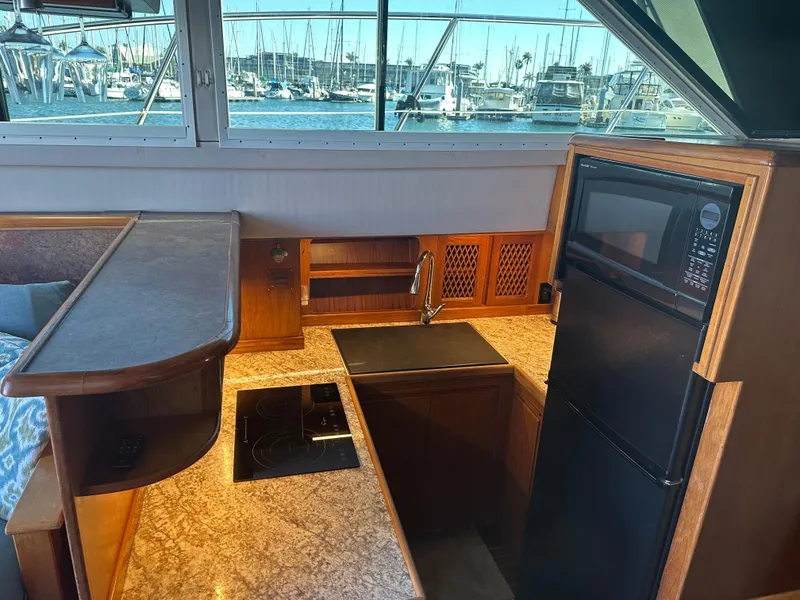 Slide: The Image of Interior of 1991 Symbol 39 Sedan Sportfisher with kitchenette, sink, and appliances. - 21