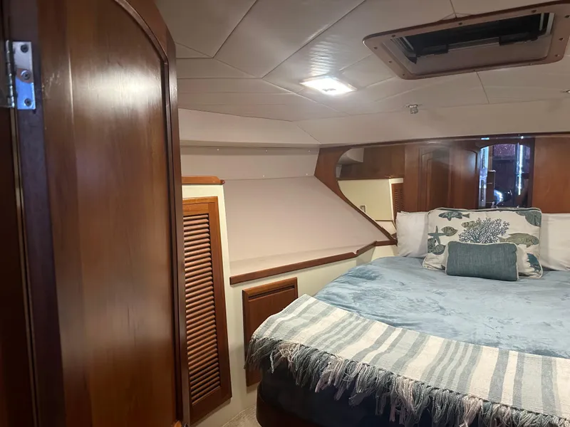 Slide: The Image of Interior of 1991 Symbol 39 Sedan Sportfisher with cozy bed and wooden cabinetry. - 22