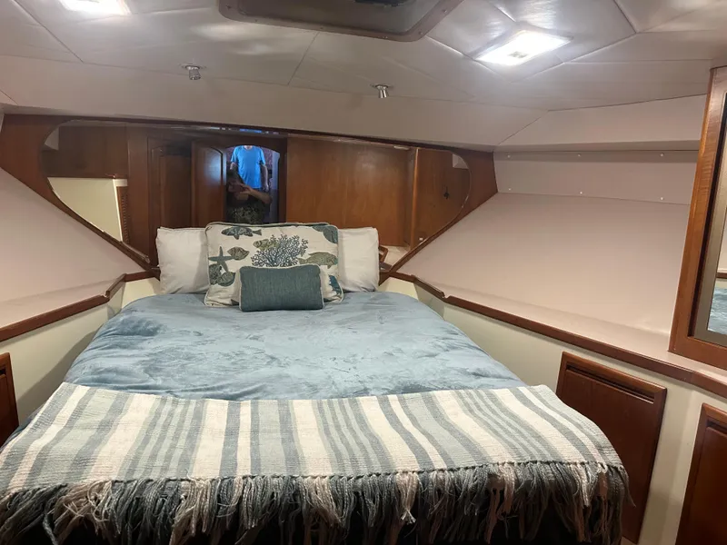 Slide: The Image of Cozy cabin interior of a 1991 Symbol 39 Sedan Sportfisher with a neatly made bed. - 23