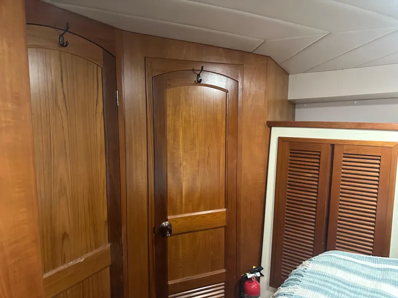 Slide: The Image of Interior of 1991 Symbol 39 Sedan Sportfisher with wooden doors and fire extinguisher. - 25